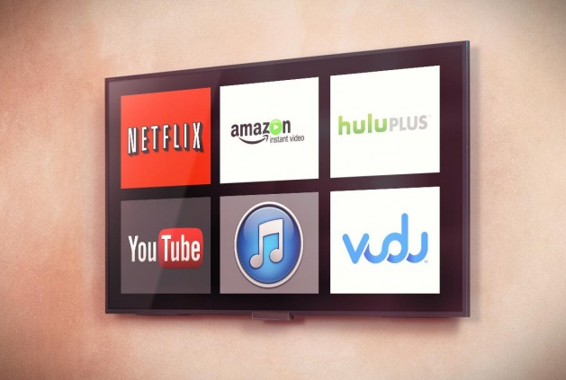 A modern TV screen displaying logos of various streaming services including Netflix, Amazon Instant Video, Hulu Plus, YouTube, iTunes, and Vudu.