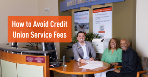 Financial Service Officer sitting with two members at desk inside credit union.